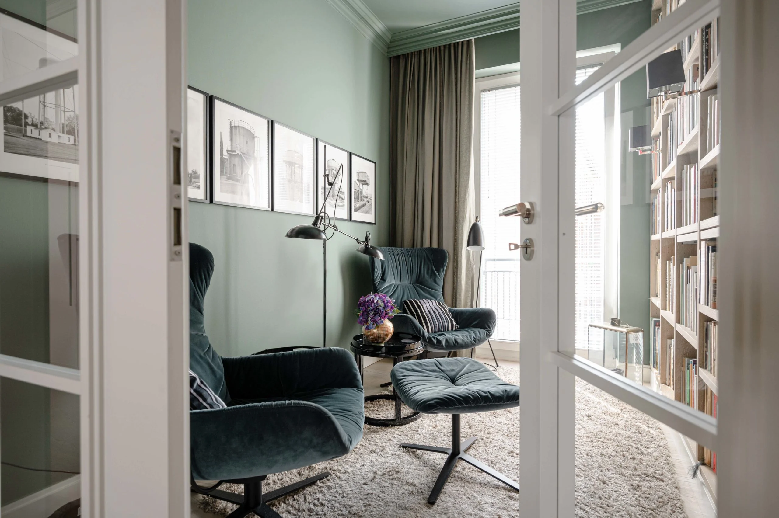 Foto von Arbeitszimmer. Grüne Wände mit Bibliothek. Grüne gemütliche Sessel. Interior Design Foto